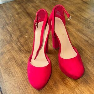 Very high red heels. Platform!